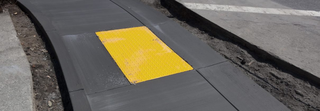 newly paved sidewalk with detectable warning system