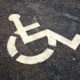 White Wheelchair Graphic on Black Asphalt