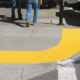 curved detectable warning tiles on sidewalk.