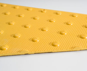 A closeup shot of an ADA Solutions Surface Applied Tactile Tile.