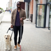 african american disabled man walking with friendly dog