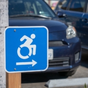 Wheel chair traffic sign pointing to the right in parking lot