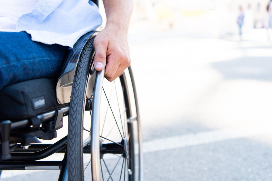 man using wheelchair on street
