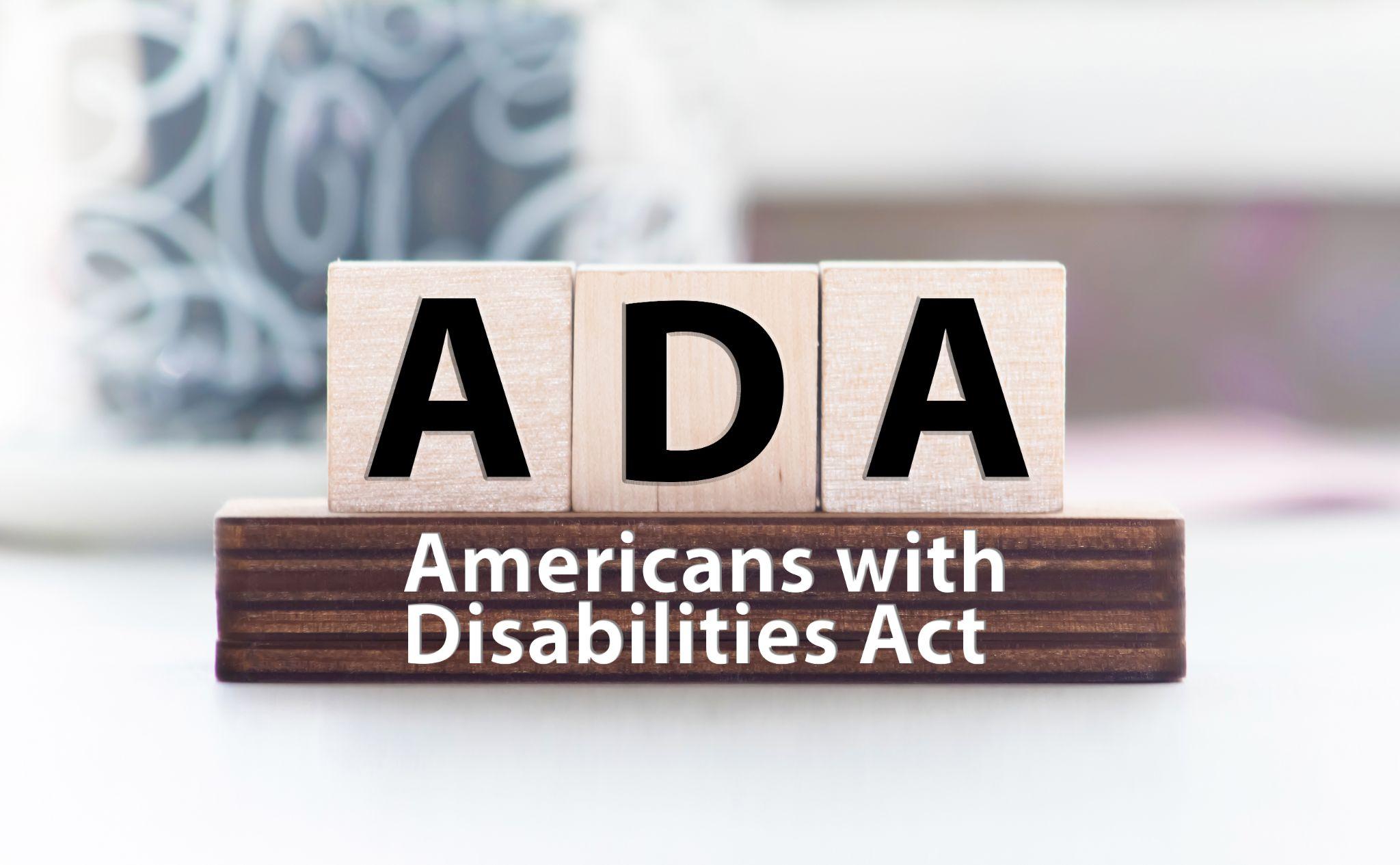 ADA Americans with Disabilities Act. text on wood cubes on white background.
