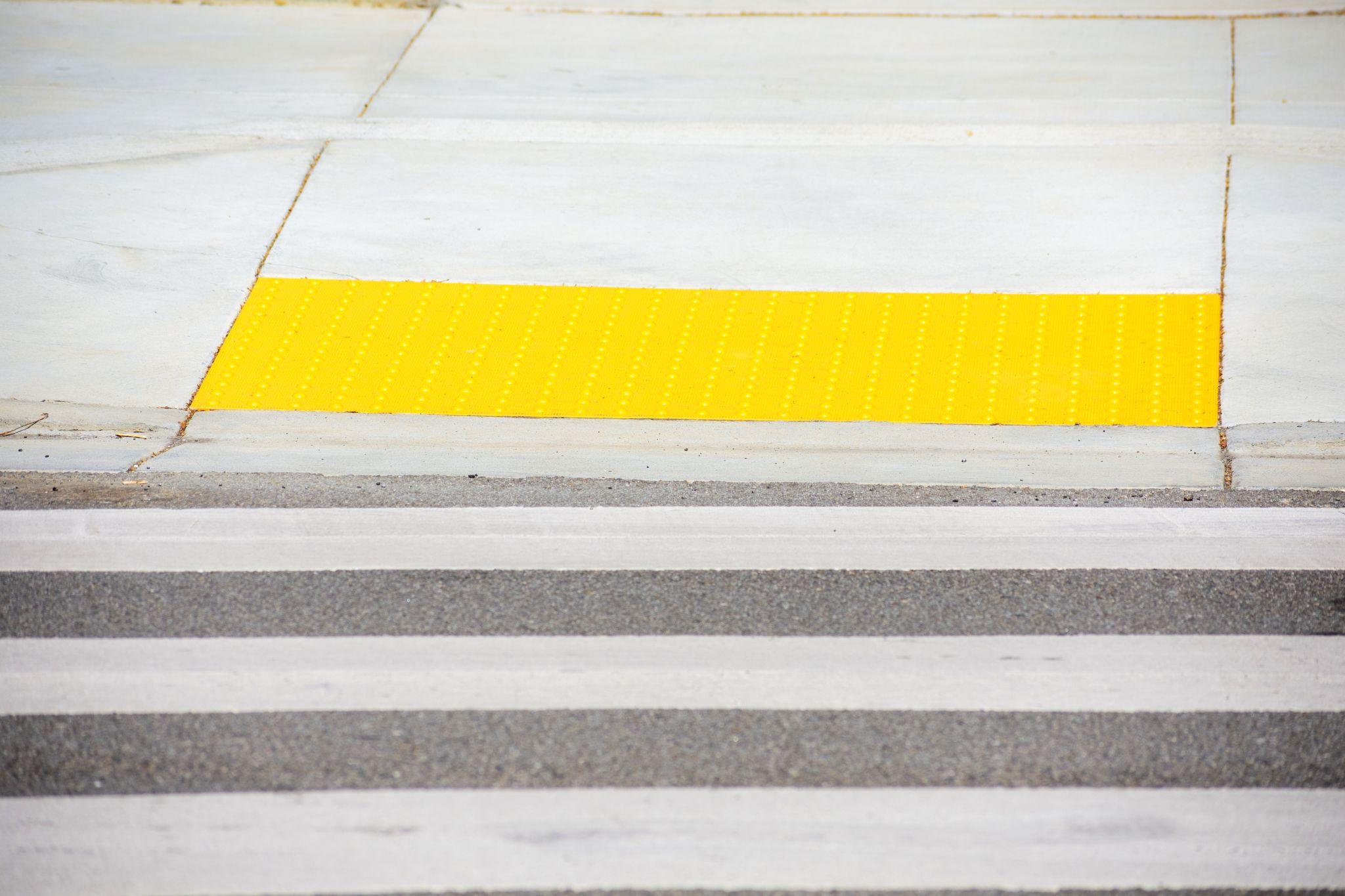 Pedestrian crossing leads to yellow detectable warning surface tactile paving