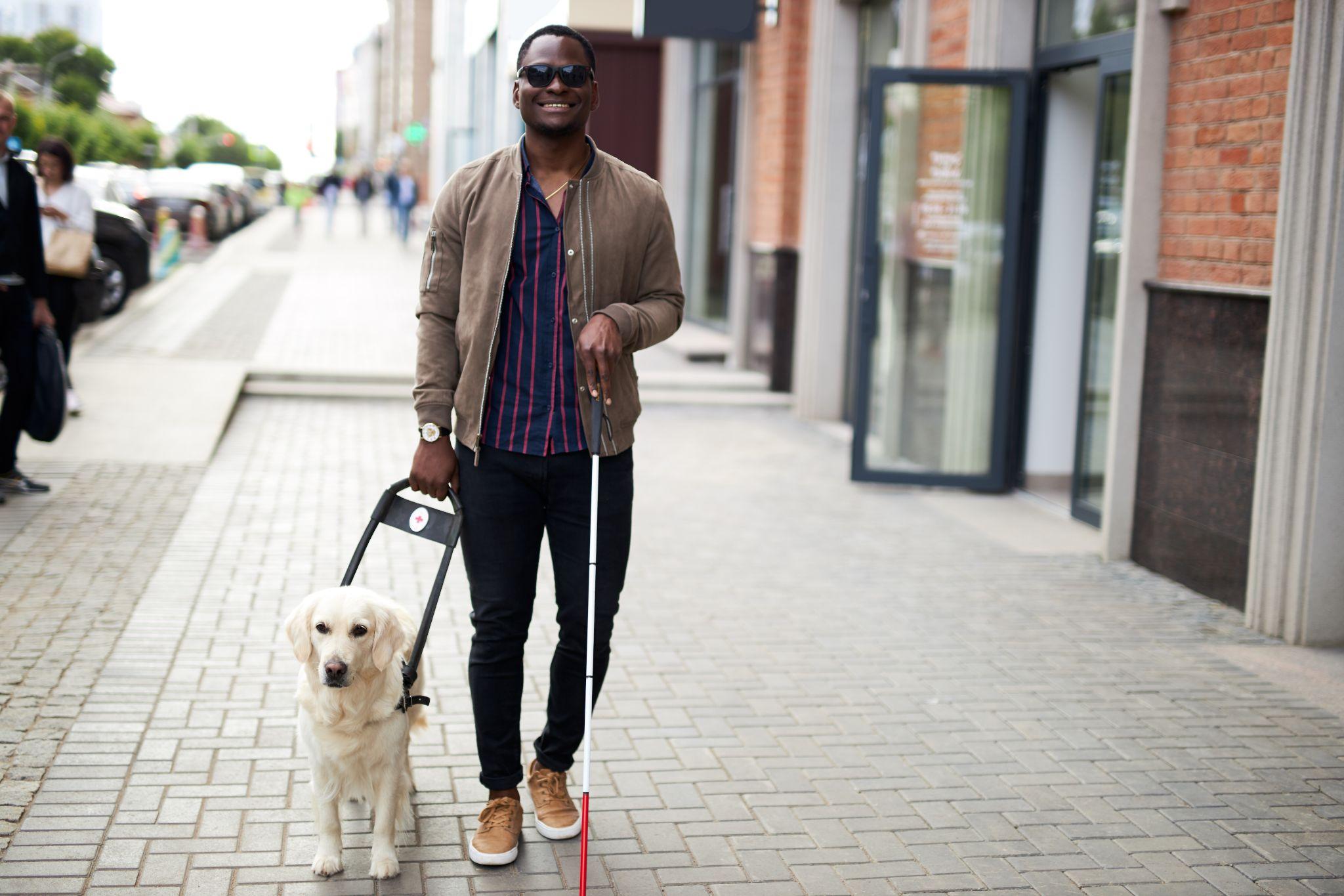 african american disabled man with helpful dog