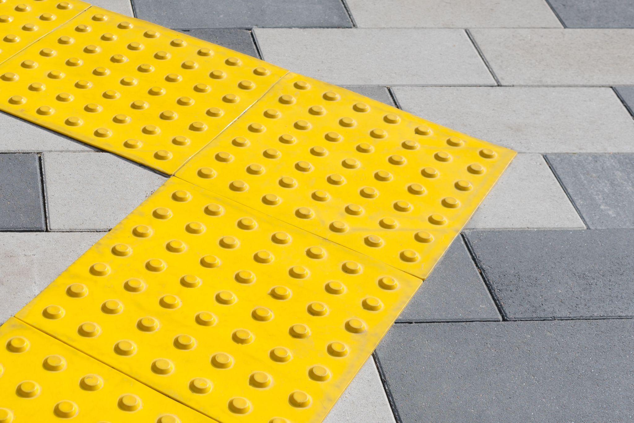 Yellow blocks of tactile paving for blind handicap.
