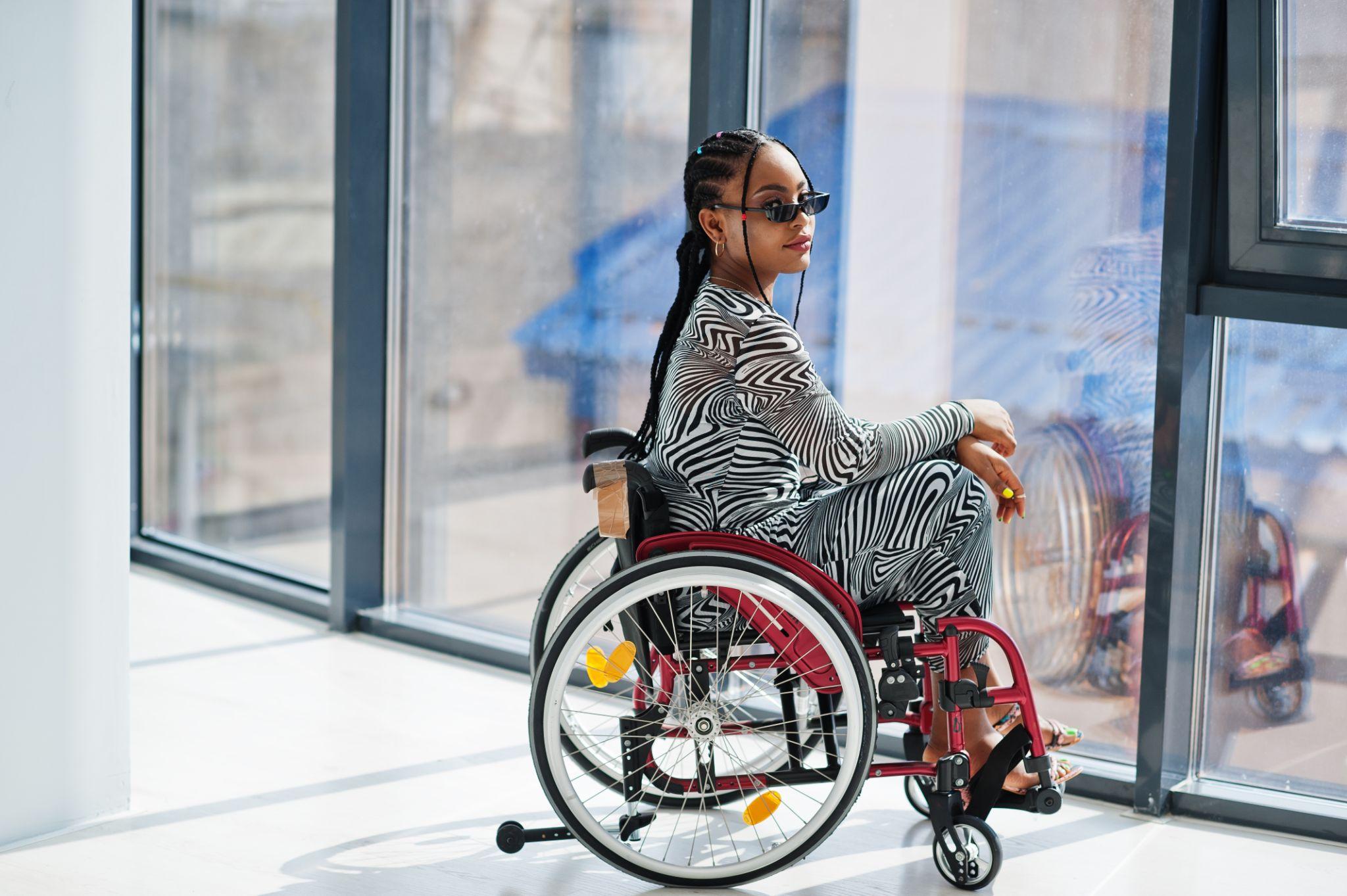 Young disabled African American woman in wheelchair at home.
