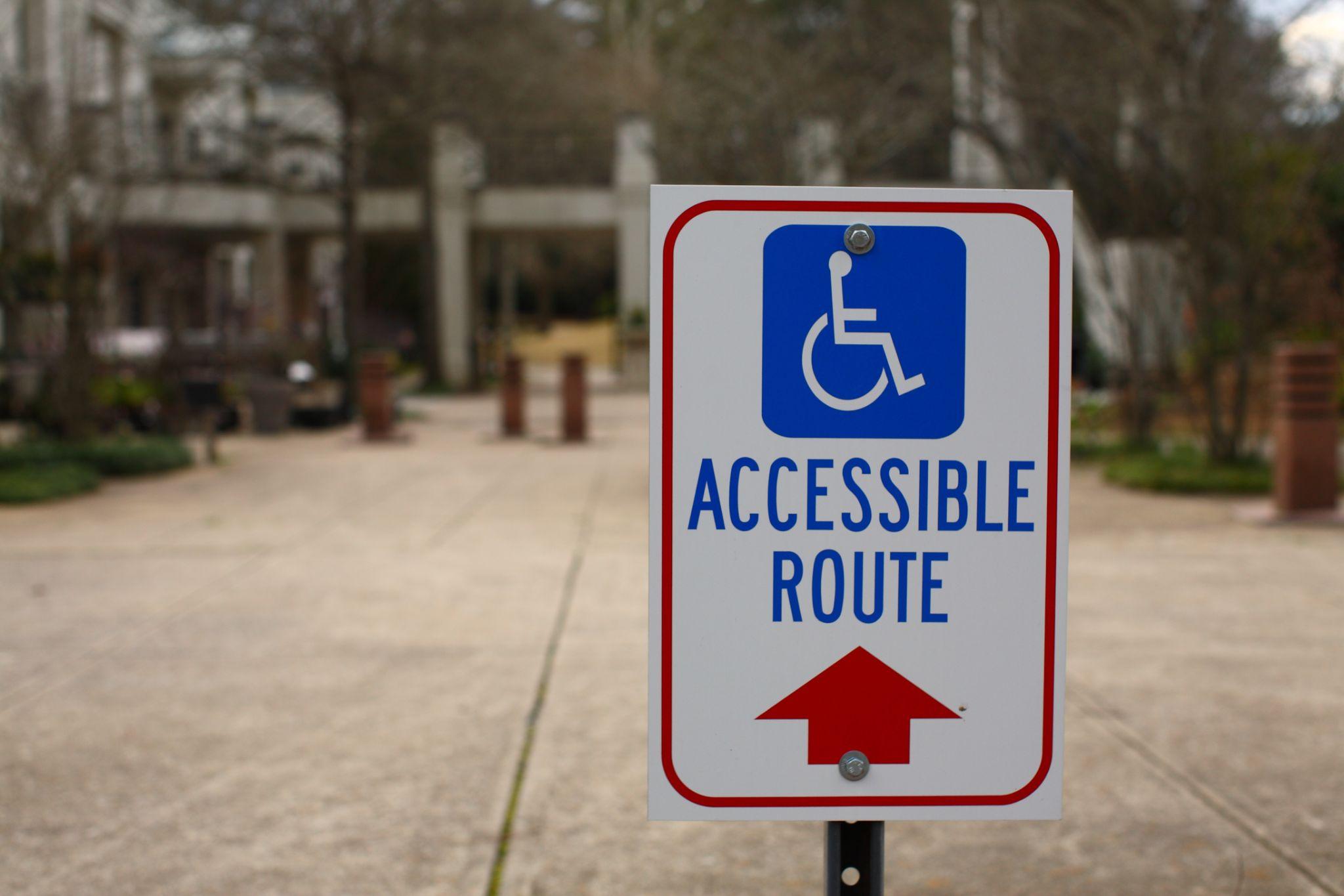 Accessible route handicap sign red arrow